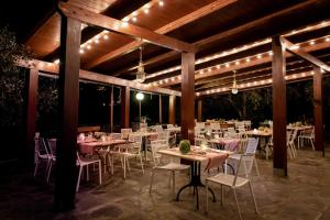 a dining area with tables and chairs and lights at Agri Suite with jacuzzi - La Bilaia in Lavagna