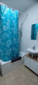 a bathroom with a shower curtain and a sink at Puerto Pesquero de Cariño in Cariño