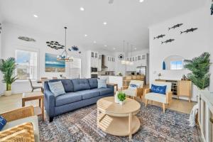 a living room with a blue couch and a table at Spacious home 1/2 mile to beach - Bikes - Fire Pit Table - Beach Gear - Infinity Table in Inlet Beach
