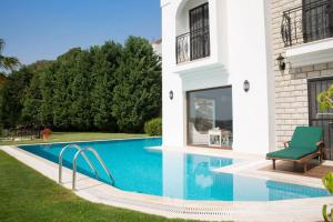 a swimming pool in the backyard of a house at Villa Rana by Important Group Travel in Yalıkavak