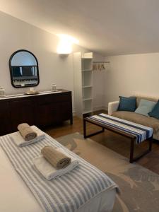 a living room with two beds and a mirror at Gite MCM in Chalais
