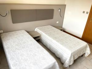 A bed or beds in a room at Hotel Villa Augusta