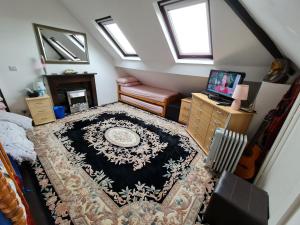 an attic room with a rug on the floor at Large private room in Biddulph-Stoke On Trent in Biddulph