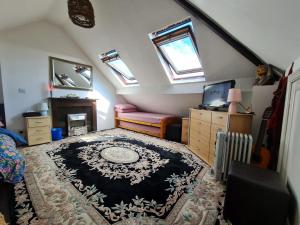 a attic room with a rug on the floor at Large private room in Biddulph-Stoke On Trent in Biddulph