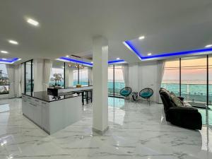 a large living room with a view of the ocean at STUNNING BEACHFRONT VIEW LUXURIOUS Apartment 30 in Jomtien Beach