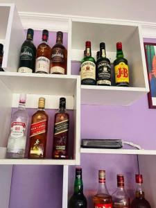 a refrigerator filled with lots of bottles of alcohol at Andromeda Executive Lodge in Ndola