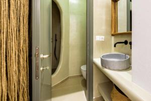 a bathroom with a sink and a toilet at KIANO SUITES in Kampos Paros