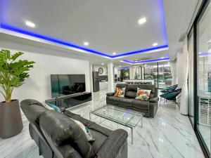 a living room with a leather couch and a glass table at STUNNING BEACHFRONT VIEW LUXURIOUS Apartment 30 in Jomtien Beach +22 photos