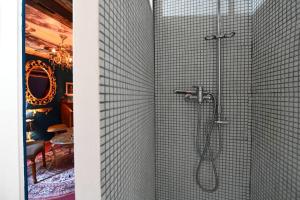 a bathroom with a shower with a shower head at Charme baroque/Séjour romantique in Mons