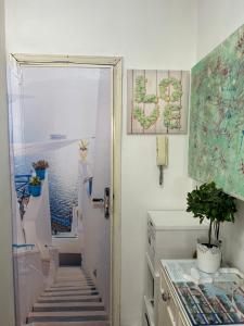 a stairway leading to a door with a view of the ocean at Residenza Parco Gioeni in Catania