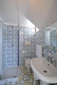 a bathroom with a toilet and a sink and a shower at La Locanda Del Fiordo in Furore