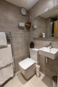 a bathroom with a toilet and a sink at Oulton House - Beautiful Restored 2 Bedroom Property in Spofforth, Harrogate in Spofforth