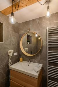 a bathroom with a sink and a mirror at Turciansky dvor - Apartmany Turiec in Martin