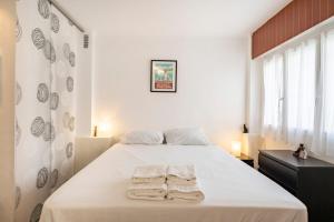 a bedroom with a bed with two towels on it at Studio near beaches and Martinez in Cannes