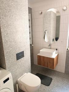a bathroom with a toilet and a sink and a mirror at Comfort apartment in Warsaw