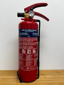a red fire extinguisher sitting on top of a table at Alojamiento Torrevieja playa frente al mar in Torrevieja