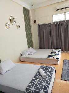 Кровать или кровати в номере Vakantie Syariah Guesthouse