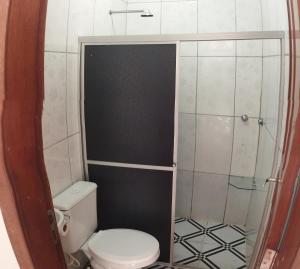 a small bathroom with a toilet and a shower at Apartamento Central Privativo in Boa Vista +25 photos