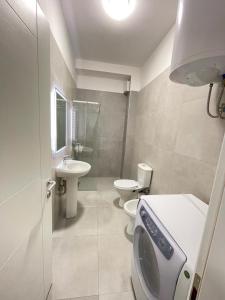 a bathroom with two toilets and a sink at Tirana AS Apartment 3 City Center in Tirana