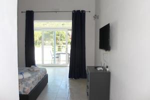a bedroom with a bed and a television in a room at ***Villa Prestige**** in Capoliveri