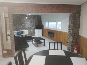 a kitchen and dining room with a brick wall at Torre de laredo 9-3 in Laredo