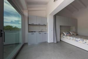 a kitchen with a bed and a sink in a room at ***Villa Prestige**** in Capoliveri