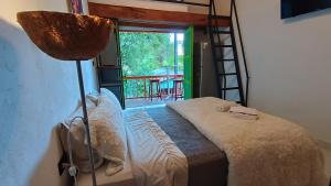 a bedroom with a bed and a ladder and a window at Hotel Marrokos Aeropuerto JMC in Rionegro