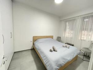 a bedroom with a bed with two stuffed animals on it at Tirana AS Apartment 3 City Center in Tirana