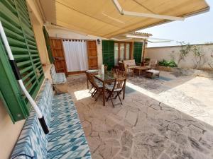 a patio with a table and chairs on it at Dau 39 in Montuiri