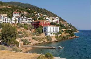 a group of buildings on a hill next to the water at Modern Studio by the sea in Loutra Edipsou