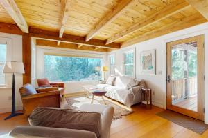 a living room with a couch and a table at Light-filled Retreat in Mad River Valley in North Fayston