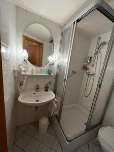 a bathroom with a shower and a sink at Landgasthaus waldhorn in Forbach
