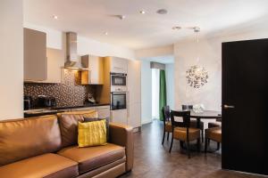a living room and kitchen with a couch and a table at EPIC Apartments Seel Street in Liverpool