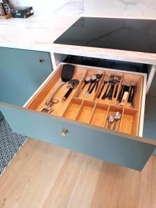 a drawer in a cabinet filled with cooking utensils at Comfort apartment in Warsaw