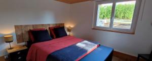 a bedroom with a large bed with a window at Villa Garona avec billard proche Pyrénées in Cazères