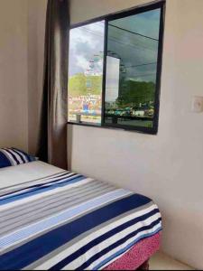 a bedroom with a bed and a window with a view at Departamento vista al mar in Montañita