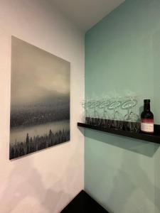 a shelf with wine glasses and a picture on a wall at Relaxen im Weindorf Mayschoß Fewo 3 in Mayschoß