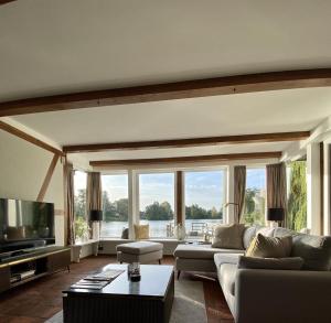 a living room with a couch and a large window at Landhaus Lotten in Winsen