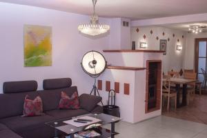 a living room with a couch and a table at Boardinghouse Schnaitheim in Heidenheim +14 photos