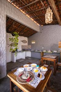 a table with plates of food on it in a room at Pousada Villa Aruna in Barra Grande