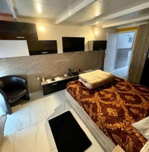 a bedroom with a bed and a chair in it at Cute Penthouse in Marsaskala