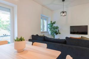 a living room with a couch and a table at Charming Alvalade, in prestigious area of Lisboa. in Lisbon