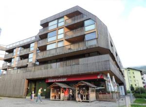 a building with people walking in front of it at Apartma Tisa Bohinj in Bohinj