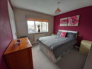 a bedroom with a bed and a desk in it at Turners Escape in Dinnington