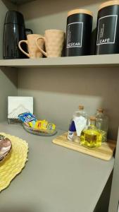 a shelf with items on it in a kitchen at Confortável Studio no Park Sul próximo ao aeroporto in Brasilia