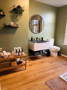 a bathroom with a sink and a mirror at J&S Downtown Sky Attic House in Belfast