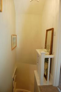 a bathroom with a sink and a mirror at Bronhaul Cottage in Pennal in Pennal