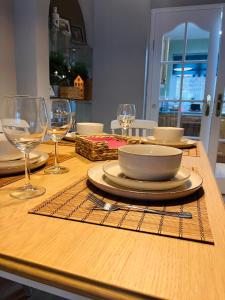 a wooden table with wine glasses and a bowl on it at J&S Downtown Sky Attic House in Belfast