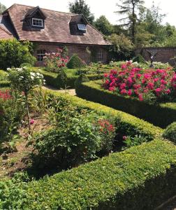 a house with a garden with flowers and bushes at The Lodge at Briar house in Long Melford