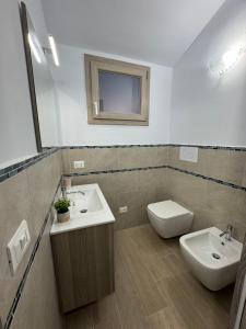 a bathroom with a sink and a toilet and a mirror at Sea View House 6 in Olbia +10 photos